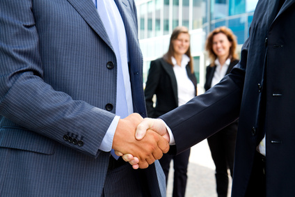 Handshake in front of business people